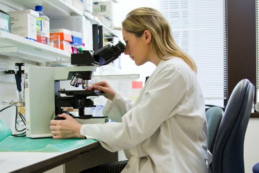 Student looks into a microscope